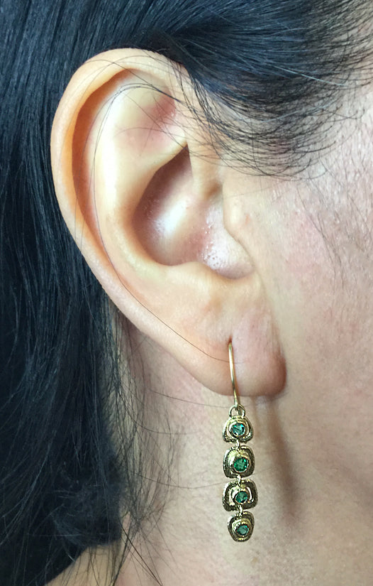 Emerald Open Pebble Dangle Earrings on ear