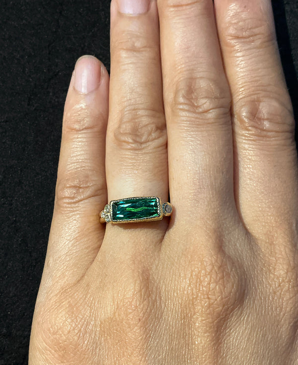 Delicate Double Elongated Blue Green Tourmaline on hand