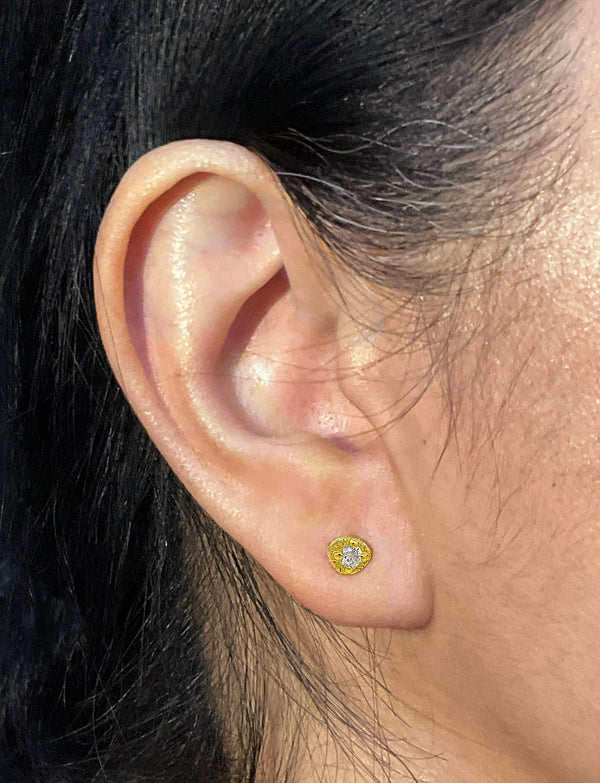 Diamond Pebble Stud Earrings in 18k yellow gold on ear