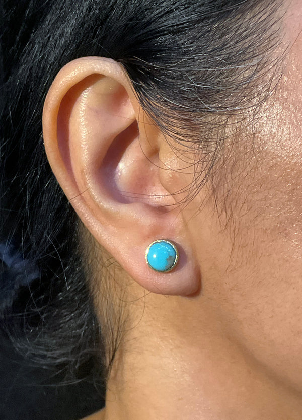 Turquoise Stud Earrings in 18k gold on ear