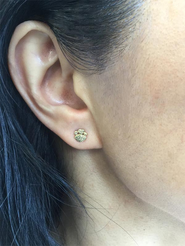 gold pebbles stud earring on ear