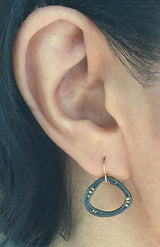 Open Pebble Soft Triangle Dangle Earring on ear