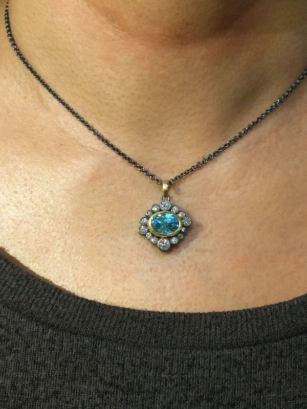 Halo Blue Zircon and Diamond Pendant on neck