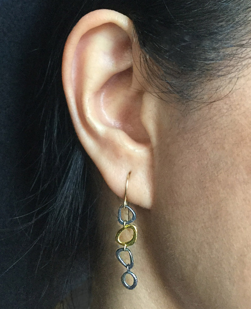 Dangle chain earrings on ear