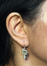 Open Cascading Pebbles Earrings worn on ear