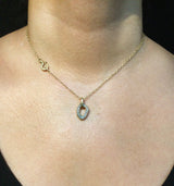 White diamond pendant on neck