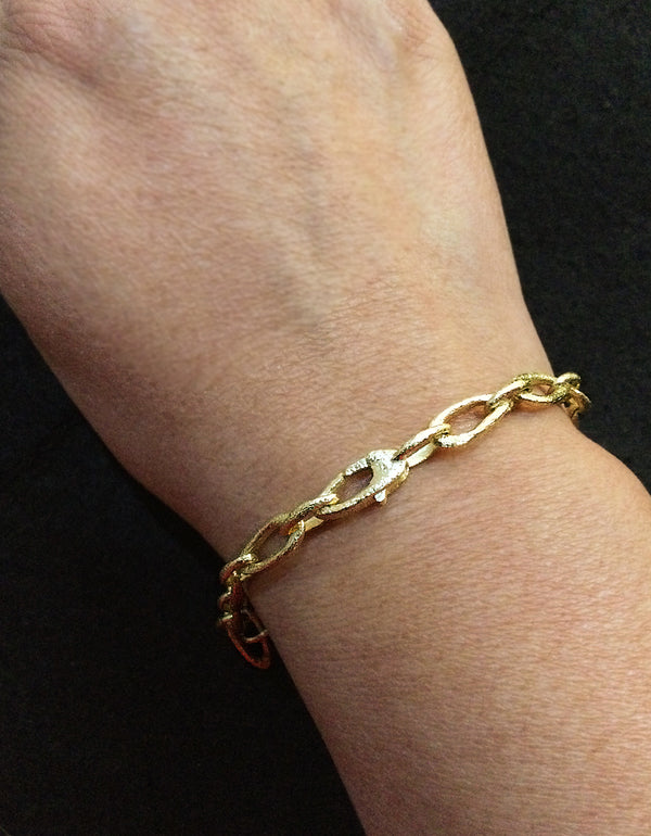 Organic small link gold bracelet on arm