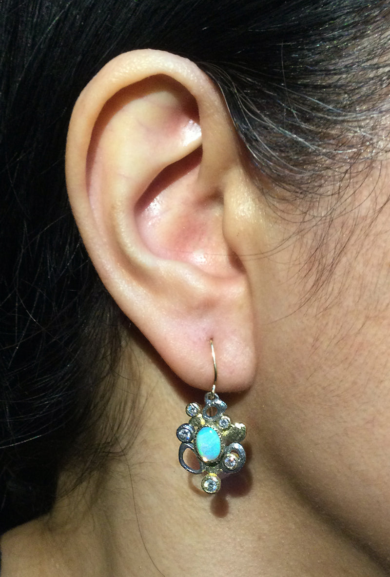 Cascading Pebbles Dangle Earrings with opal and diamonds on ear