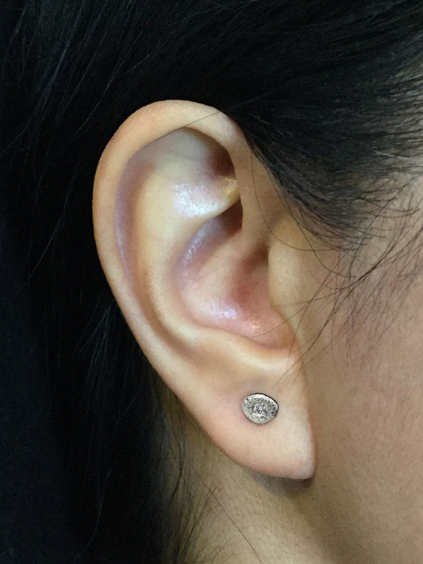 Single Pebble Diamond Stud Earrings on ear